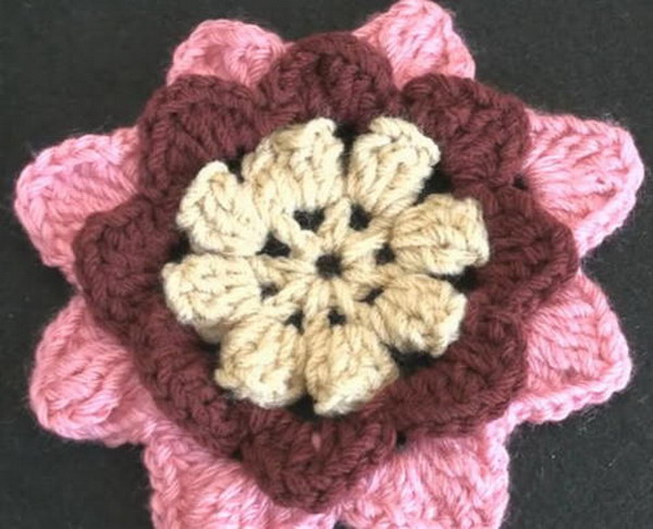 Irish crochet flower brooch in variegated orange and white cotton yarn